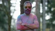 4K Portrait Of Serious Hipster Guy Being Covered In Coloured Powder At Festival Stock Footage