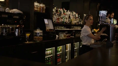 4K Portrait Smiling Bar Worker Standing Behind Counter In Fashionable City Bar Stock Footage 75780149