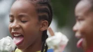 4K Portrait Of Smiling Brother &Amp; Sister Enjoying Ice Creams In The Park Stock Footage