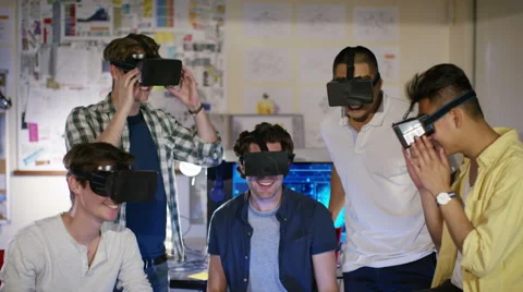 4K Portrait of smiling computer programmers trying out virtual reality viewers Stock Footage 54428307