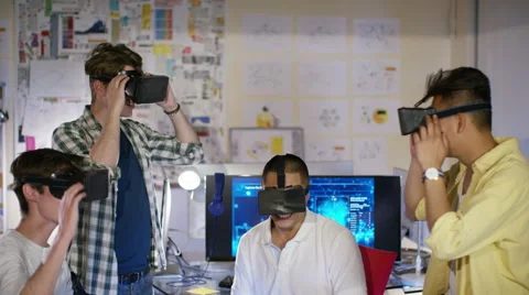 4K Portrait of smiling computer programmers trying out virtual reality viewers Stock Footage 54428693