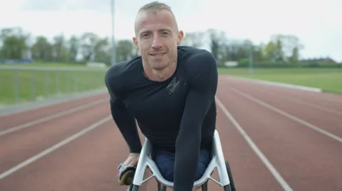 4K Portrait of smiling disabled athlete in specialist wheelchair at racing track Video stock 64570305