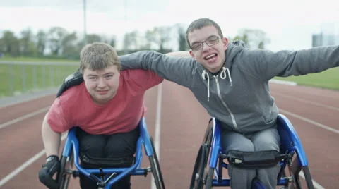 4K Portrait of smiling disabled athletes in wheelchairs at racing track Stock Footage 64570693