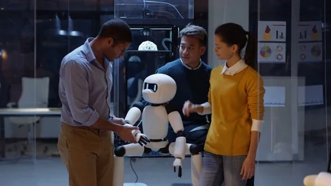 4K Portrait smiling electronics team building robot with 3D printed components Vídeos de archivo 73835584