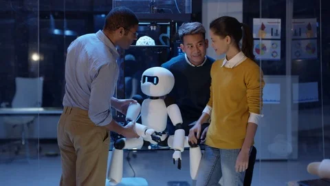 4K Portrait smiling electronics team building robot with 3D printed components Vídeos de archivo 73837171