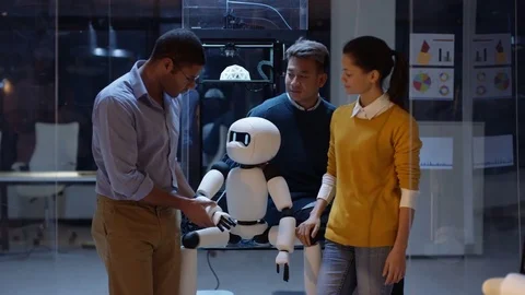 4K Portrait smiling electronics team building robot with 3D printed components Vídeos de archivo 73837410