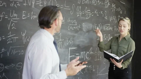 4K Portrait smiling man with tablet &amp; woman writing math formulas on blackboard Stock Footage 67878388