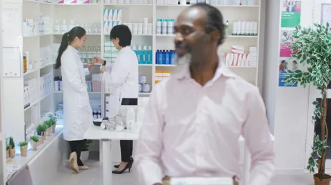 4K Portrait of smiling mature man at the pharmacy. Stock Footage