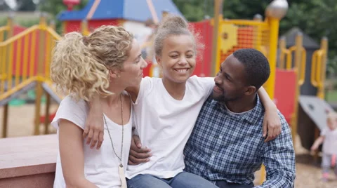 4K Portrait smiling mixed family at outdoor adventure playground Stock Footage