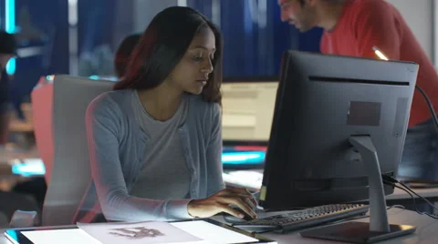 4K Portrait smiling young computer game designer drawing at her desk Stock Footage 67902926