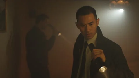 4K Portrait of tough guy cop investigating crime scene with his partner Stock Footage 66429957
