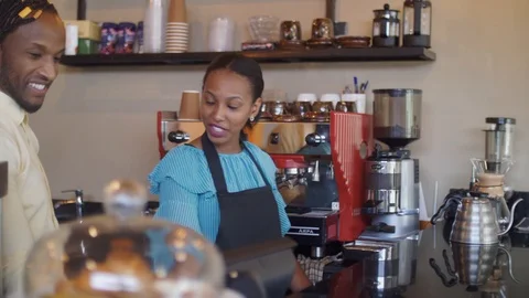 4K portrait of two friendly smiling workers standing behind the counter. Vídeo Stock 111340397