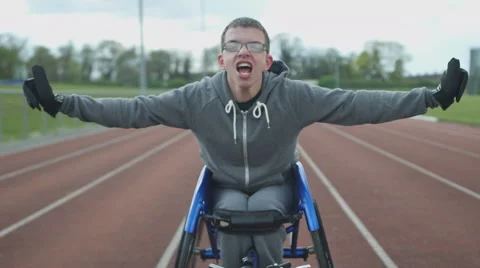 	4K Portrait of young disabled athlete in racing wheelchair at sports track Video stock 64579782