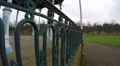 4K POV gopro walking along an iron fence with park in the distance 4k or 4k+ Resolution