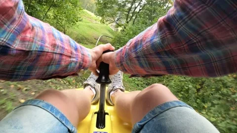 4K POV man going down a mountain coaster summer toboggan alpine coaster track Stock Footage 157013349