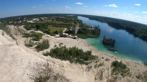 4K POV man walking up to a cliff edge looking at abandoned prison Rummu quarry Stock Footage 157013247