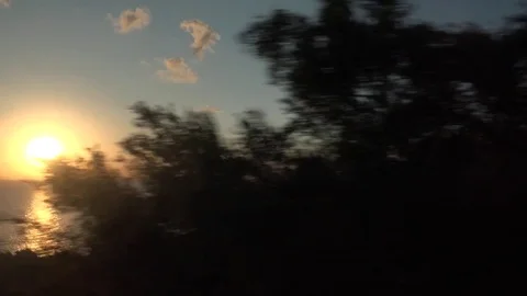 4K POV Point of view car drive on sea coastline sunset light sun silhouette day Video stock 80058943