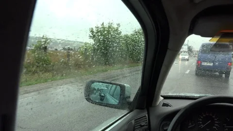 4K POV Point of view car drive slowly in rainy day bustling traffic wet street Stock Footage 80073168