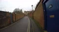 4K POV walking along bricked lane with blue door and double yellow lines 4k or 4k+ Resolution