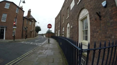 4K POV walking through rustic red bricked town along road with traffic signs Stock Footage 59728289