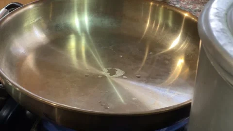 4K pre-heating stanless steel pan Stock Footage 242457556