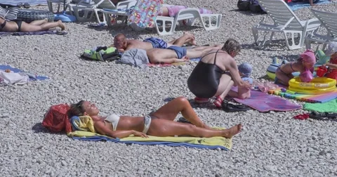 4K Primosten sunbathing on the beach Stock Footage 45788941