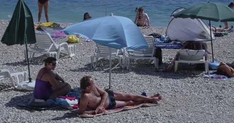 4K Primosten sunbathing on the beach Stock Footage 45790092