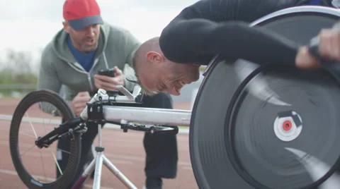 4K Professional disabled athlete training in racing chair on roller machine  Stock Footage 64581631
