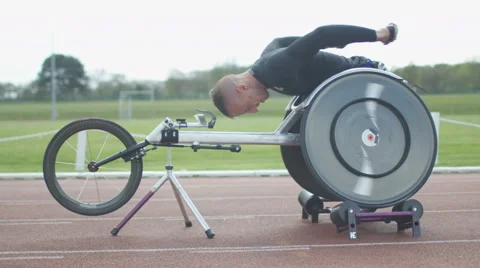 4K Professional disabled athlete training in racing chair on roller machine Stock Footage 64582684