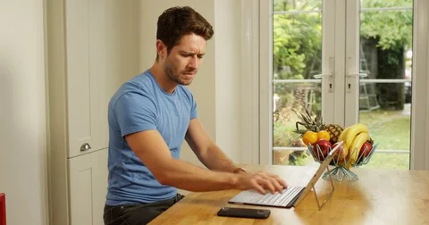 4K Professional man working from home, dealing with a business issue over phone Video stock 80456453