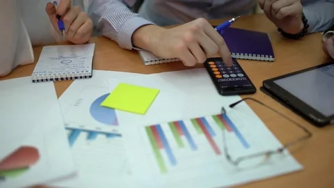4K Professional team looking over figures and projections in business meeting Stock Footage 85055078