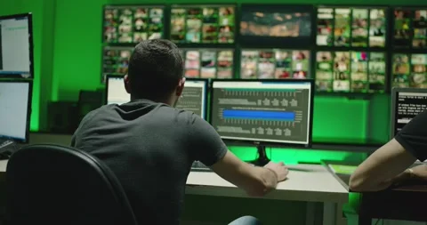 4K Programmers using many laptops computers  following information, statistics . Stock Footage 163546200