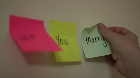 4k proposal with post it notes- caucasian hand ""will you marry me?"" Stock Footage 61166481