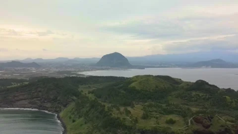 4K Pull-off Aerial View of Mt. Songaksan (송악산) with Mt. Sanbansan in View, Jeju Stock Footage 143864145