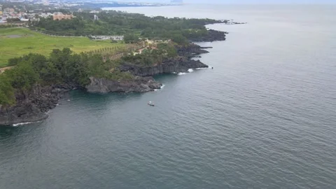 4K Pull-away Aerial Shot of Jusangjeollidae (주상절리대) cliffs, Jeju Volcanic Island Stock Footage 143863617