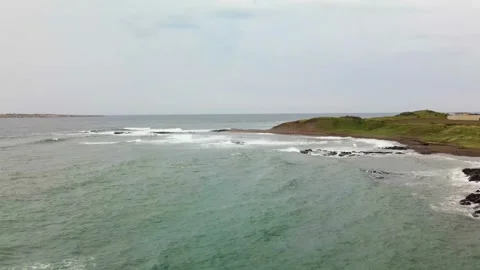 4K Pull-off Low Flight over a Seacoast near Mt. Songaksan (송악산), Jeju Island Stock Footage 143864026
