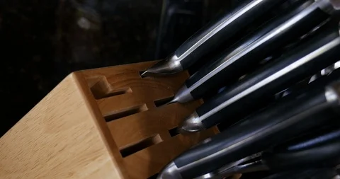 4K Pulling Chef knife from knife block close up Stock Footage 100094332