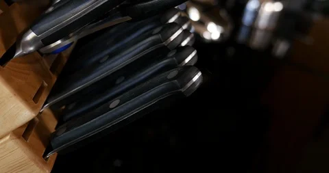 4K Pulling steak knives from knife block Stock Footage 100094462