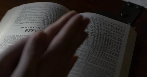 4K Rack Focus of Hands Praying Over Bible and Man Practicing his Religion Stock Footage 106576888