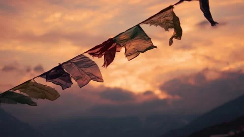 4K Rack focus shot of prayer flags waving in the wind in front of snowy Himalaya Stock Footage 291646547