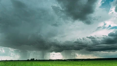 4K Rain Rainy Clouds Above Countryside Rural Field Landscape With Young Green Stock Footage 159134038