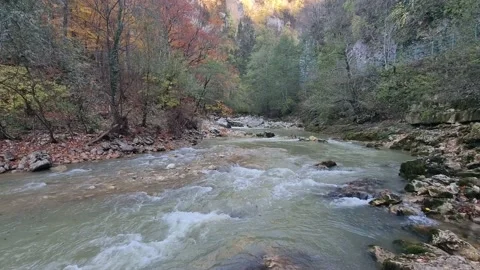 4K. Rapids of a stormy mountain river with fast water and large stones. Stock Footage 220443340