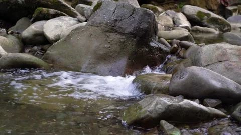 4K. Rapids of a stormy mountain river with fast water and large stones. Video stock 220443376