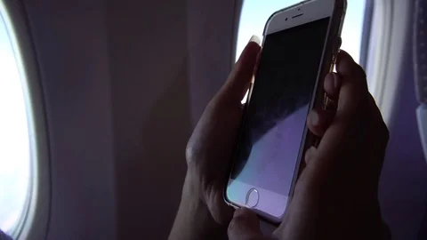 4K raveller sit down inside the plane using phone device to writting message-Dan Stock Footage 74741500