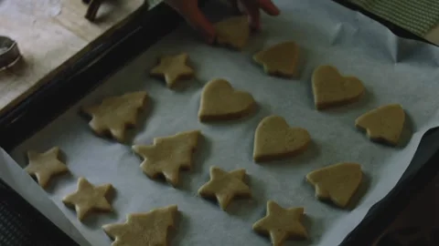 4K Raw Gingerbread Shapes Arranged Evenly on Parchment Stock Footage 342113453