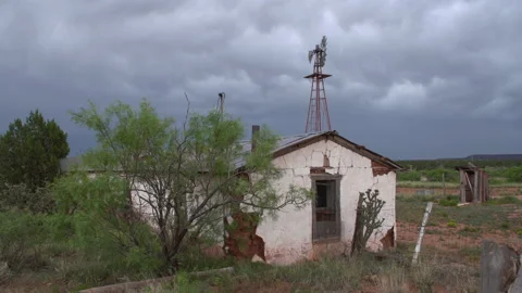 4K Real Time of an abandoned ranch house and dark rain clouds in New Mexico Stock Footage 170676577