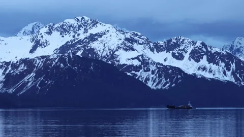 4K real time of a cargo ship and snowy mountains at blue hour in Seward, Alaska Stock Footage 242889888