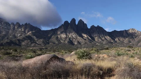 4K real time of Clouds shading The Organ Mountains peaks in New Mexico Stock Footage 229336034