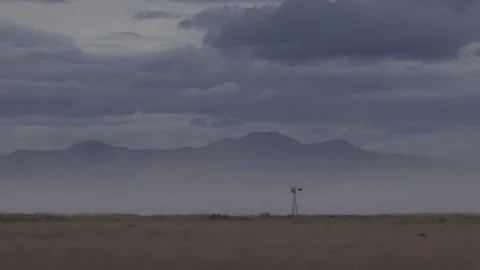 4K real time of a lonesome windmill in a winter dust storm on Arizona plains Video stock 229317878