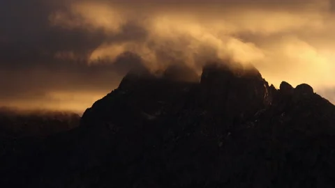 4K real time long shot of Sunset Clouds blowing past The Organ Mountains Stock Footage 229008440